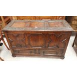 An early 20th century oak mule chest with carved and moulded decoration