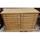 A modern wooden collectors cabinet of 18 drawers