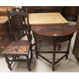 A carved oak demi-lune hall table and chair