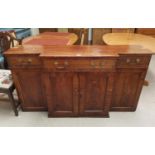 An early 19th century breakfront side cabinet in crossbanded figured mahogany, the 3 frieze