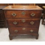 A Georgian oak 3 drawer chest with brass drop handles on pierced back plates, on bracket feet