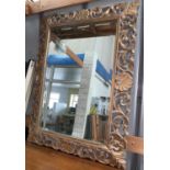 A large bevelled mirror in ornate Florentine carved frame (mirror glass a.f.); 2 large picture