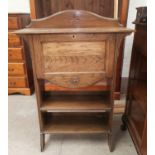 An oak Arts & Crafts secretaire with fall front and 2 drawers under