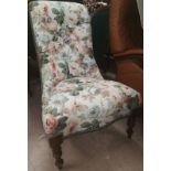 A Voctorian mahogany nursing chair in floral upholstery