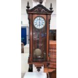 A 19th century walnut Vienna wall clock with ebonised and turned mouldings etc, white dial and