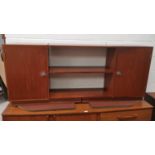 A France and Son teak side unit with central shelves and cupboards to either end