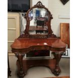 A Victorian mahogany 'duchess' style dressing table with shaped mirror on carved brackets,