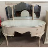 A Louis XV style oval dressing table in cram and gilt finish, with 5 drawers, on cabriole legs