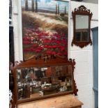 A large early 20th century wall mirror in Chippendale style fretwork frame; a similar smaller mirror