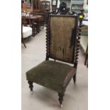 A Jacobean style rosewood nursing chair with barley twist columns and carved crest, needlwork
