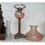 A Victorian style brass and pink glass oil lamp