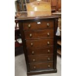 An early 20th century stained wood Wellington chest with key and wooden letter rack