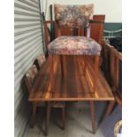 A 1950's walnut dining suite comprising rectangular table, 4 chairs and sideboard