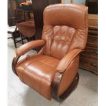 A German Himolla modern tan leather armchair on rocking /swivel wooden base
