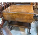 A teak coffee table with magazine under; a 1930's oak barley twist tea trolley, 2 tiers with drop