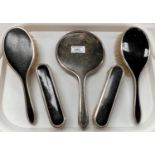 A 5 piece dressing table set with silver and tortoiseshell backs; a cased part manicure set