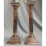 A pair of silver Corinthian column candle sticks on square weighted bases B 1962 net weight 20oz,