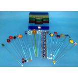 A collection of 21 coloured glass swizzle sticks decorated with fruit; etc.