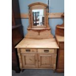 An Edwardian stripped pine dressing table with 2 drawers and double cupboard