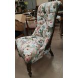 A Victorian mahogany nursing chair in floral upholstery