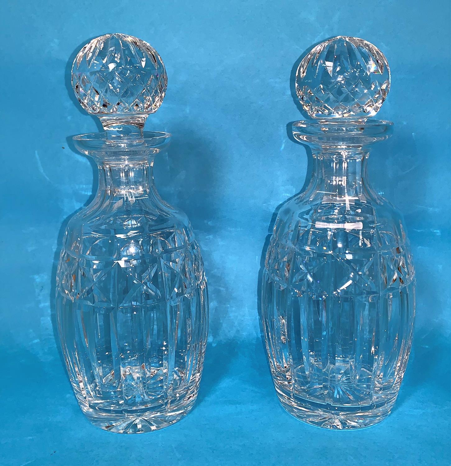 A pair of Waterford Crystal decanters, height 10"; another similar (a.f.)