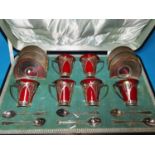 A Royal Doulton flambé ware 6 setting coffee set, cased, the conical cups in silver Art Nouveau