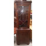 A mahogany reproduction full height corner cupboard by Jaycee, with astragal glazed door to the top