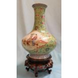 A late 19th/early 20th century Chinese squat baluster vase with long slender neck and raised foot,