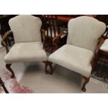 A pair of 1930's Georgian style armchairs with upholstered seats and backs