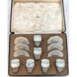 A Coalport boxed set of 6 white porcelain coffee cups in pierced silver holders, Birmingham 1942