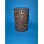 An oriental carved bamboo brush pot depicting man charging on horseback height 13cm