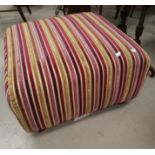 A multi coloured footstool/pouffe