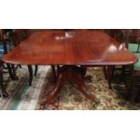 A late Georgian mahogany supper table with rounded rectangular tilt top, on turned central column, 4