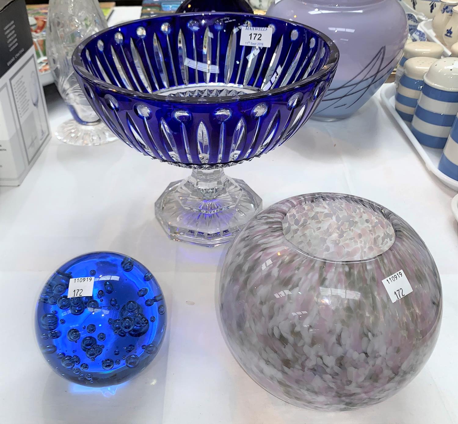 A modern blue overlaid fruit bowl on pedestal, diameter 10"; a spherical spatter glass vase; a