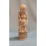 A Chinese carved ivory handle to a walking stick depicting a bald figure 9.5cm