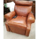 An electric reclining armchair in tan hide