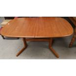 A 1960's teak extending dining table with rounded rectangular top