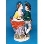 A 19th century porcelain group in the Derby manor depicting a young man and woman in 18th century