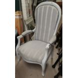 An upholsterer armchair in grey upholstery and grey finished paint