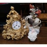 A 19th century French mantel clock in gilt metal case, surmounted by a woman with dove, white enamel