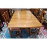 A period style golden oak dining suite comprising rectangular drop leaf table and 4 'Country