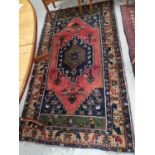 A 20th century Persian "Yahyali" rug, hand knotted, rust ground with multiple border and central