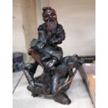 A Chinese root carving of a bearded man sitting on naturalistic base, height 31cm