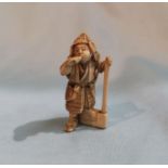 A Japanese carved ivory miniature Okimono depicting a soldier, bearing signature to base, height 5cm