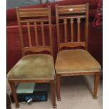 A pair of Edwardian golden oak dining chairs and a pair of other chairs