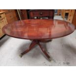 A Georgian style figured mahogany coffee table, quatrefoil base with reeded supports, 48"