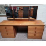 A 1970's teak 2 piece bedroom suite comprising dressing table and 3 height chest of drawers