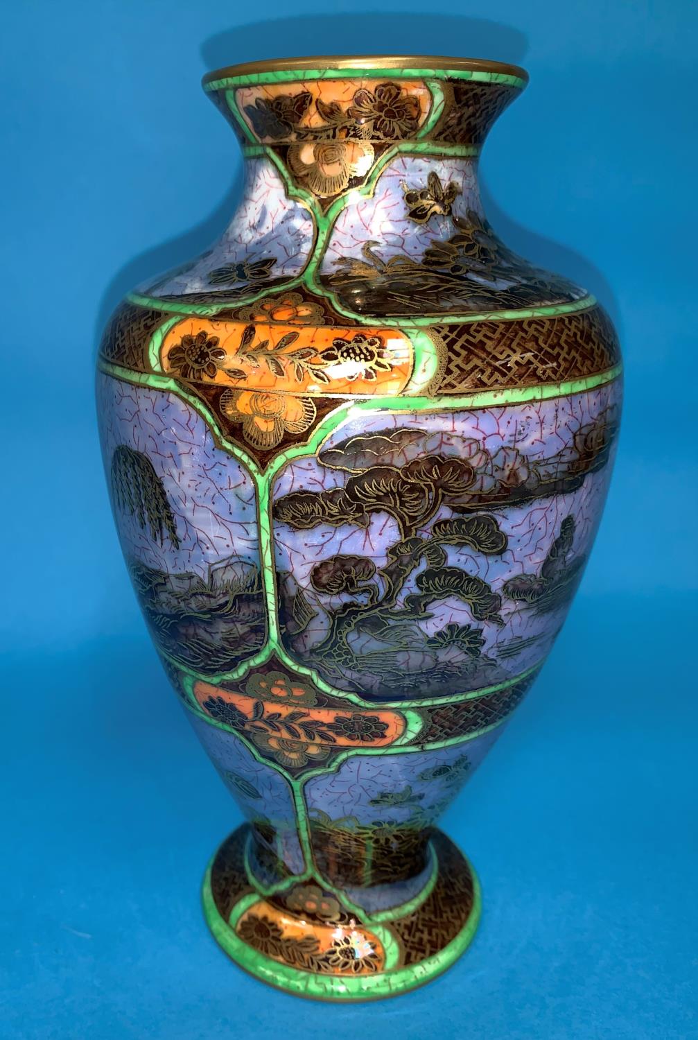 A 1930's Wedgwood lustre baluster vase decorated with chinoiserie scenes of a man in a boat, with