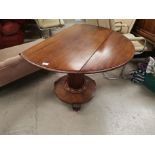 A Georgian mahogany drop end dining table on circular base