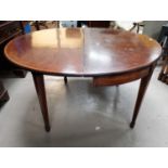 A 19th Century mahogany inlaid circular dining table with removable leaf forming demi-lune side